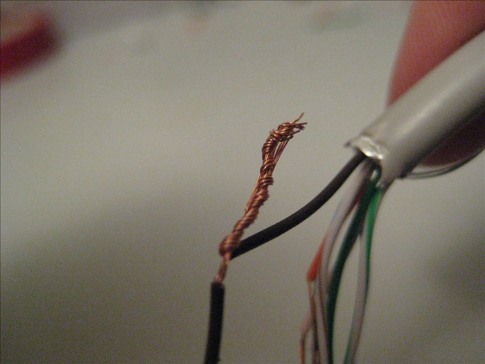 Twist the copper wires around each other. Make sure you get all of the wire into the twist.
Be careful not to have them wrap around a wire in a different colored casing.

Repeat on all the remaining wire, matching colored casings, of course.
