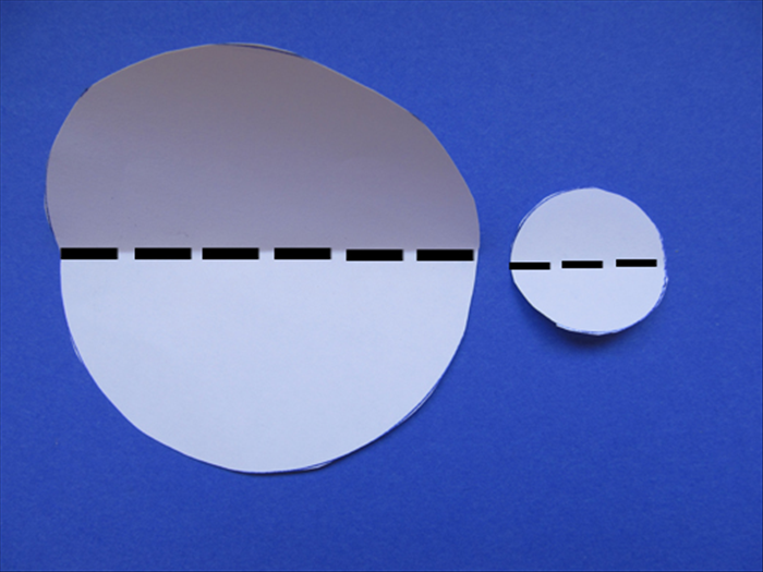 Fold the large and small paper circles in half