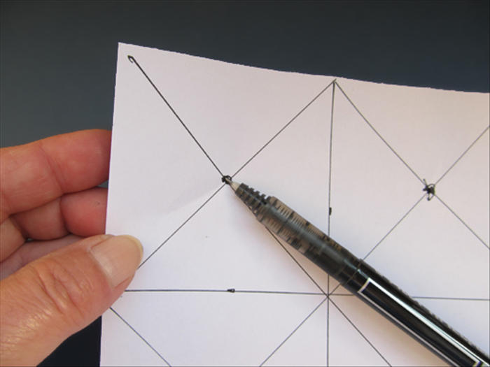 Punch a hole with the pen point through each of the dots