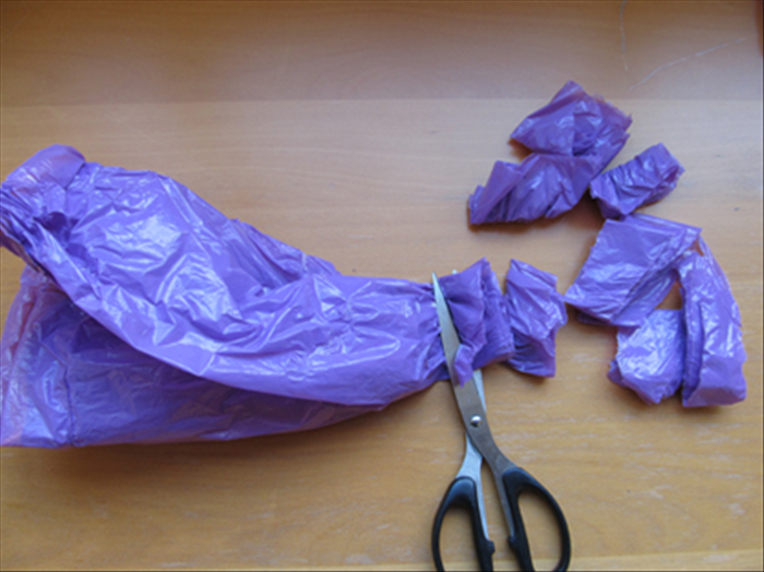 Fold the plastic bag a few time lengthwise and cut strips