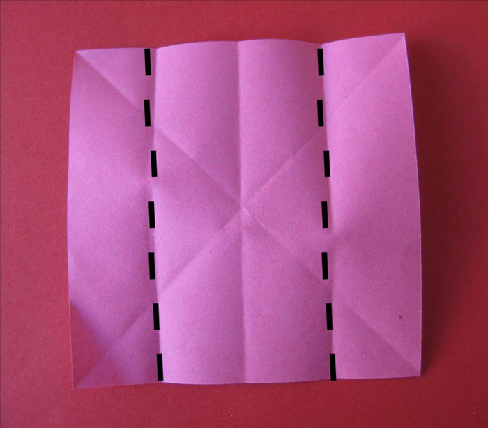 Rotate the paper so that the straight edges are on, top, bottom and sides.

Fold the side edges to the center.