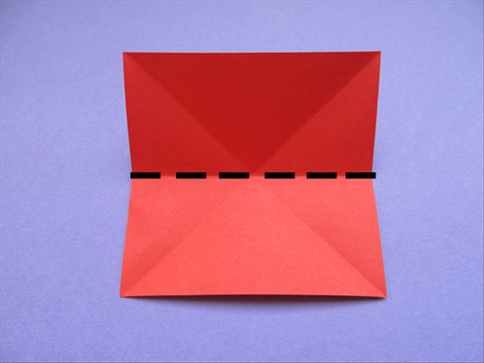 Rotate the paper so that the straight edges are at the top, bottom and sides.

Bring the bottom straight edge to the top to fold in half
Crease and unfold
