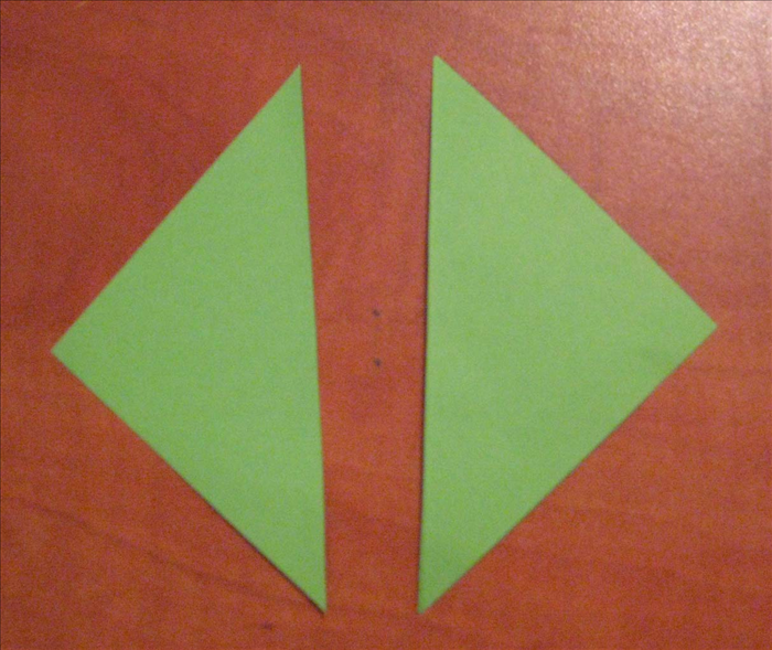 Place  the square paper for the stem with its points on the top. bottom and sides.

Fold it in half vertically.
Use the crease line to cut the paper in half.
.
You will be using only one half of the paper to make the stem.