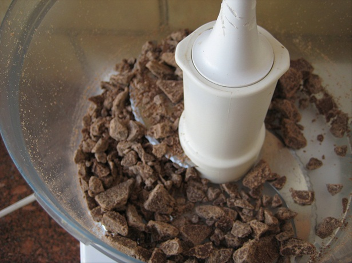 Break the chocolate bar into the squares and chop a few seconds in the food processer.

Remove to a bowl.
