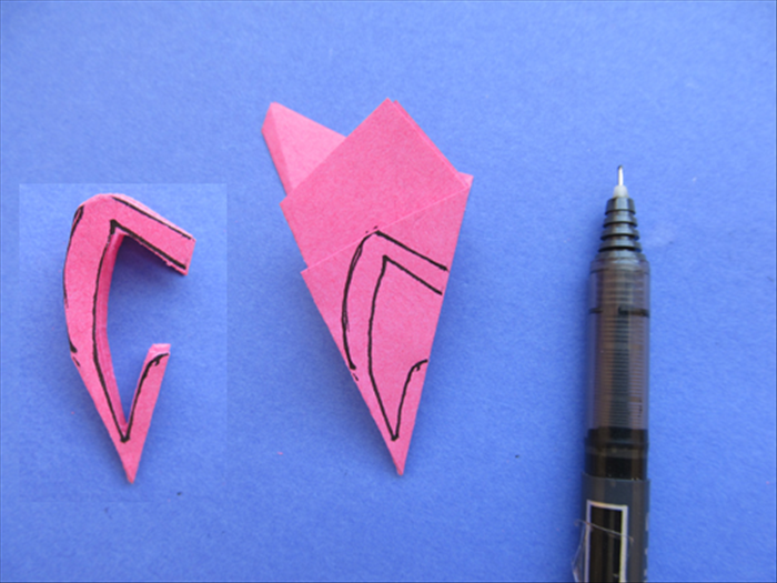 To make a flower with the cherry blossom petal shape:

Start to draw the line from about ¼ of the way down on the right side to the middle of the top edge of the top  layer. 
Draw a slightly arced line down to about half way of the right side. 
Follow the line and continue with the v shape at the bottom as shown in the picture.

Cut along the outside of the lines as you did in the last flower shape

