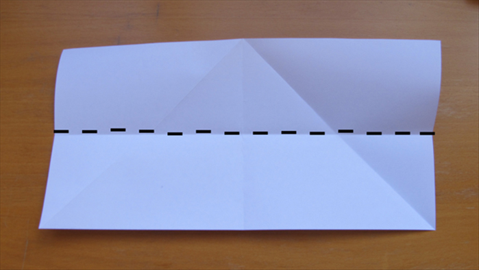 Open up the paper and fold it in half lengthwise. 
Unfold