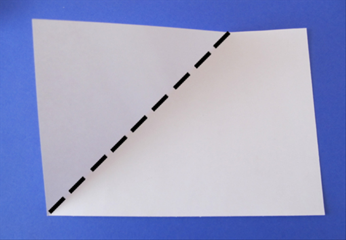 Place the paper with the writing facing up and the long edges at the top and bottom

Fold the upper left corner down and align the side with the bottom edge
