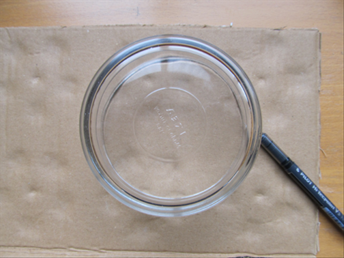 Use the large circular object to trace another circle on cardboard and cut it out