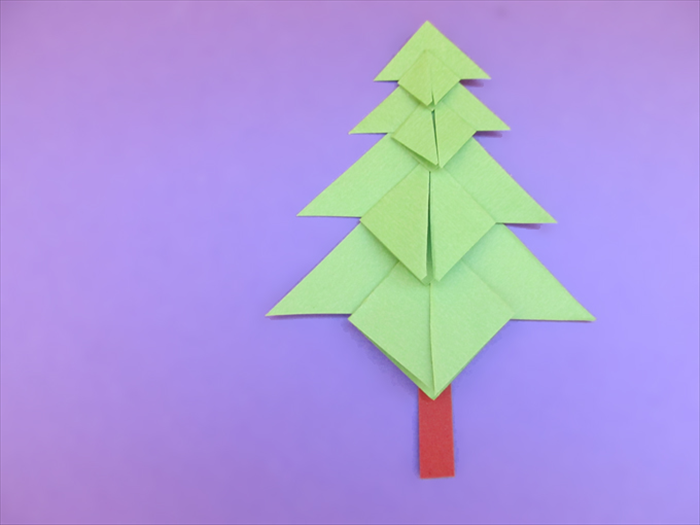 Materials:
Square green paper - 1 square each - 4 inches, 3 inches, 2 inches and 1 inch
Scissors
Paper glue
1 small piece of brown paper for the tree trunk
